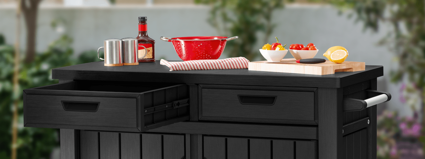 Keter outdoor buffet storage cabinet styled with food and drinks for outdoor entertaining.