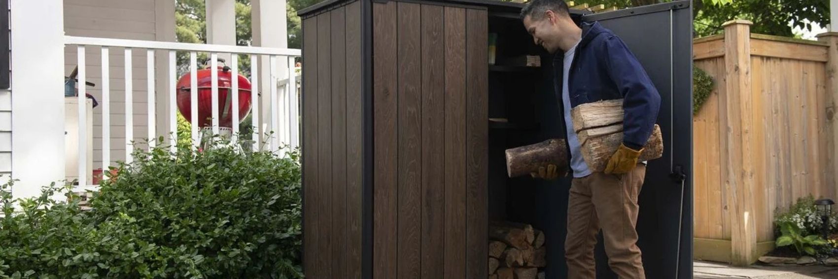 Keter outdoor cupboard used for garden and firewood storage on a patio