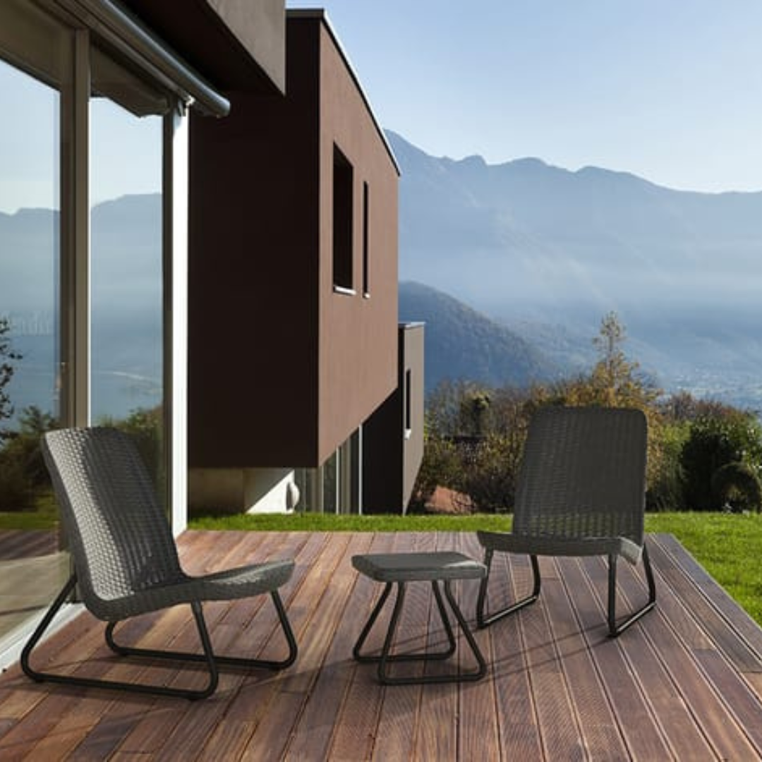 Rio Patio Set in graphite with two wicker-look chairs and a matching side table on a wooden deck overlooking mountain scenery