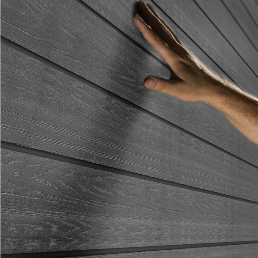 Hand touching the durable resin wall panels on the Cortina 11x7ft garden tool shed