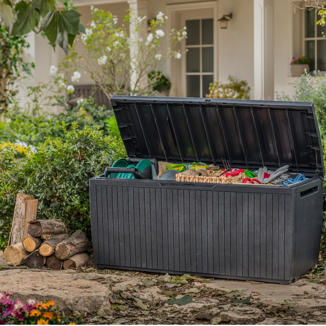Springwood 305L Storage Box with an open hinged lid revealing garden tools in a dark ribbed resin finish