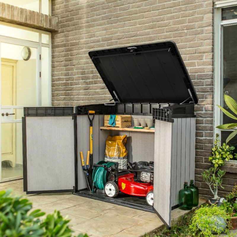 Elite Store outdoor storage unit with open hinged lid and double doors holding a lawnmower garden tools and watering equipment