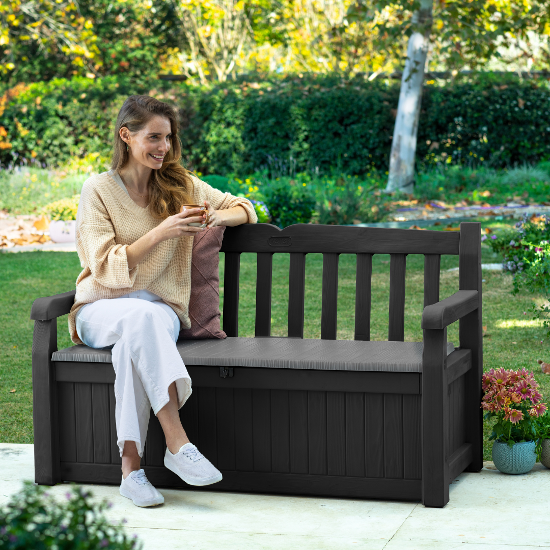 Eden 70G Bench Box Graphite with a dark weather-resistant resin bench and enclosed storage beneath the seat in a garden setting