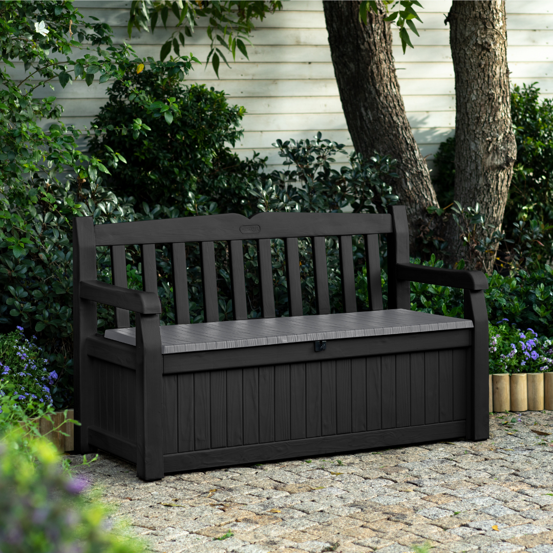 Eden 70G Bench Box Graphite in weather-resistant resin with slatted seating and a front storage compartment on a paved patio