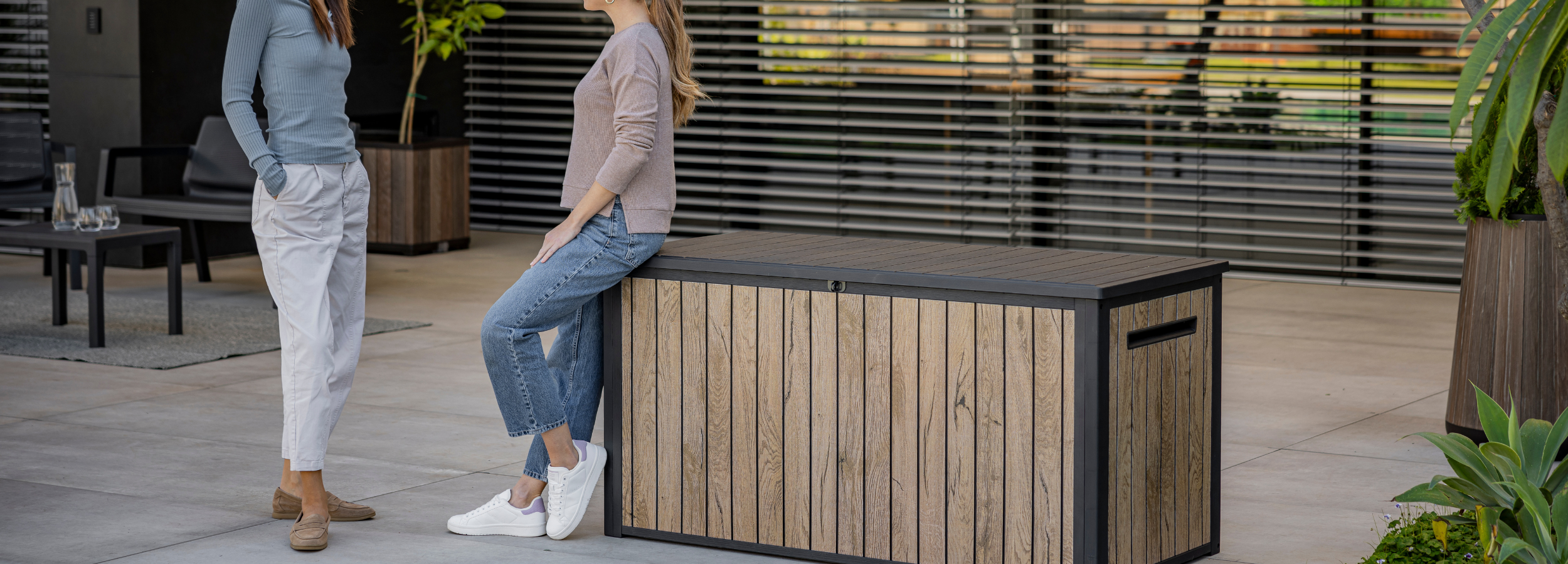 Outdoor lockable cabinet with integrated bench seating and a contemporary wood-effect design.