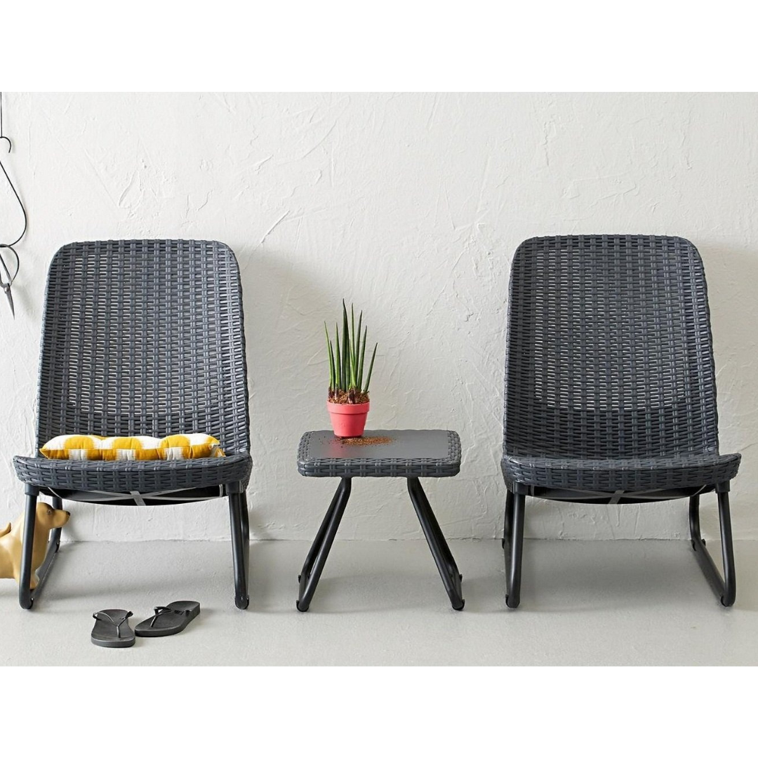 Rio Patio Set in graphite with two wicker-look resin chairs and a matching side table on a patio area