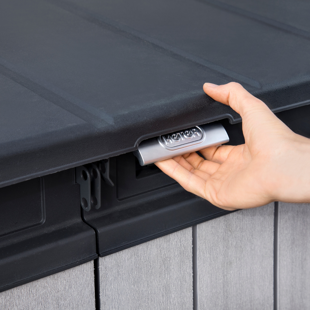 Elite Store close-up showing a hand using the integrated silver handle beneath the black lid and grey rib-reinforced walls