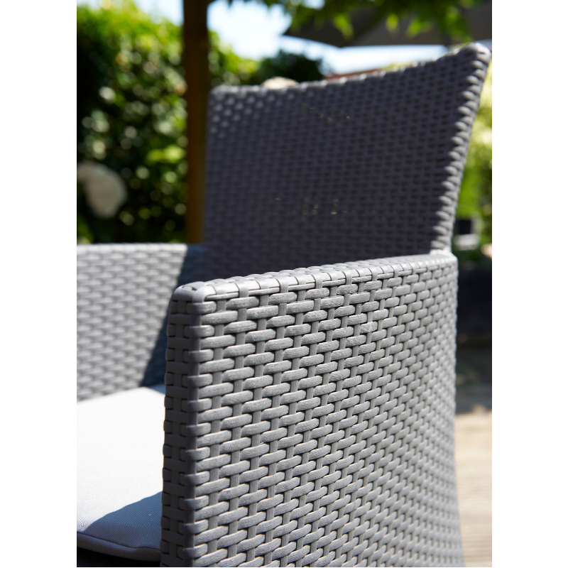 Iowa Balcony Set showing a grey flat-wicker armchair with a textured back and cushioned seat outdoors